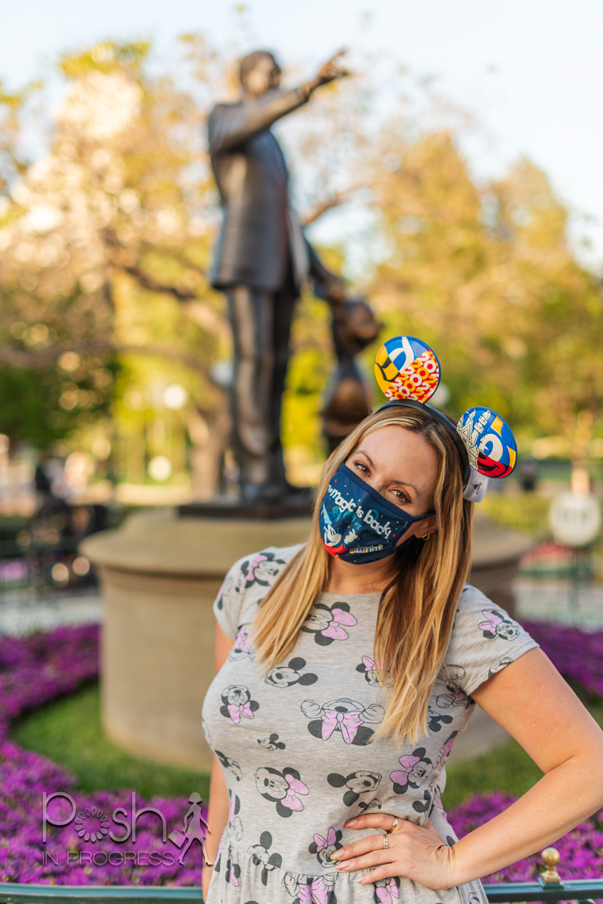 disneyland reopening 2 |  Disneyland Reopening by popular LA lifestyle blog, Posh in Progress: image of a woman wearing Mickey Mouse ears, a Disney face mask, and Minnie Mouse shirt. 